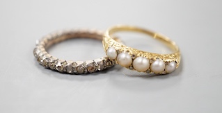 A 19th century yellow metal and rose diamond set full eternity ring, size L/M and an early 20th century yellow metal and graduated split pearl ring, size K/L, gross weight 5.8 grams.